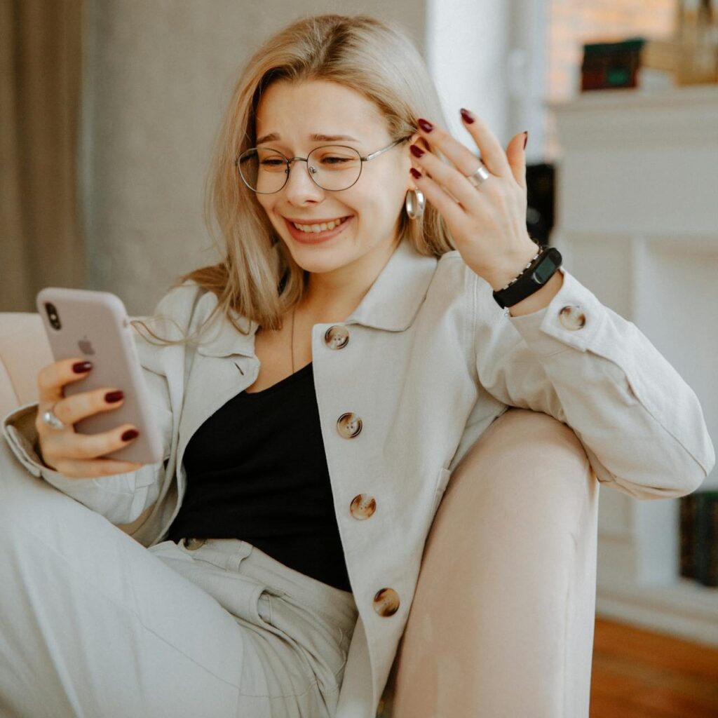Girl laughing while watching funny videos on mobile phone